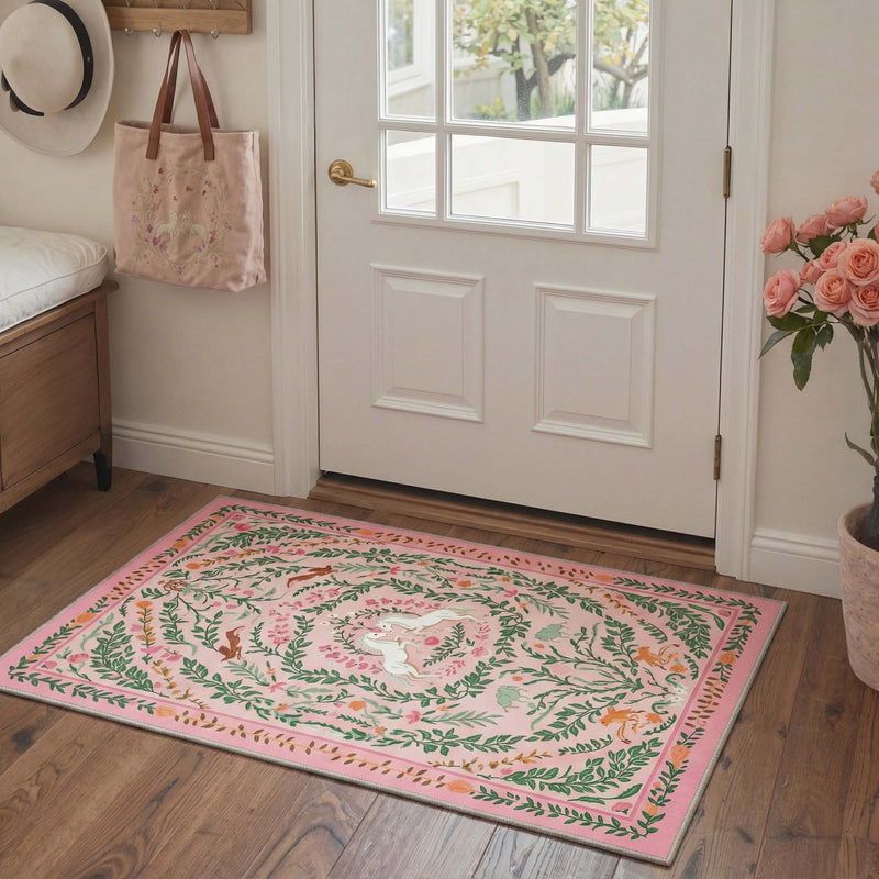 Elaria Washable Bloom Garden and Unicorn Pink Rug on wooden floor in entryway with white door