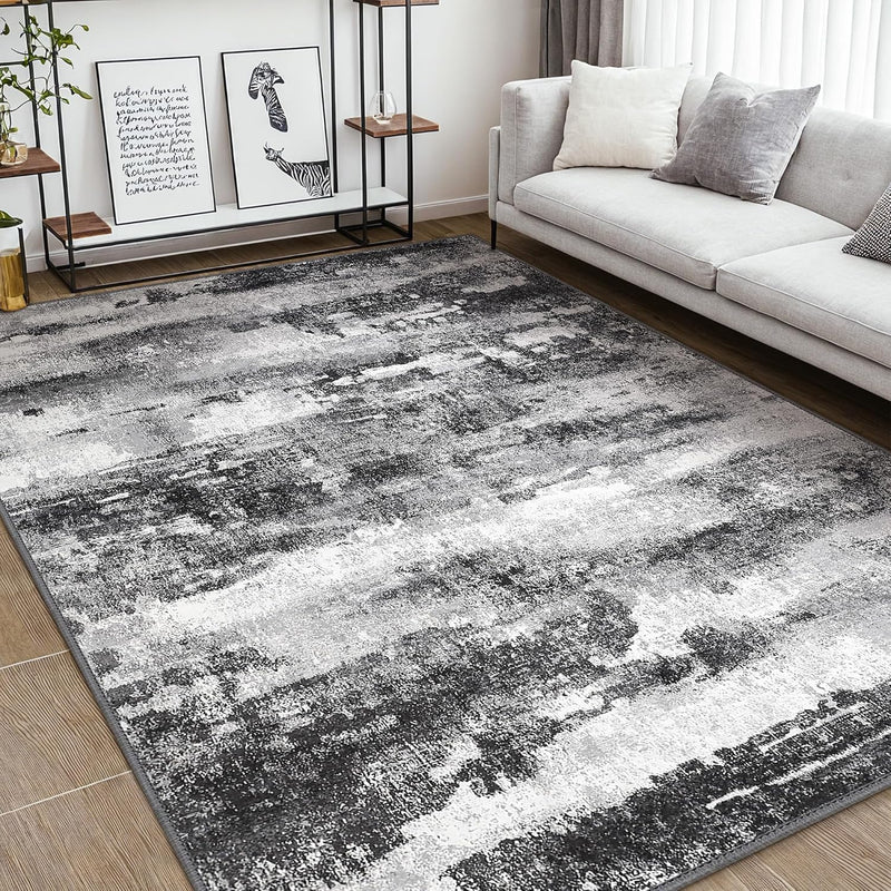 Fluxa Modern Abstract Print Soft Gray Rug on wood floor in living room next to gray sofa