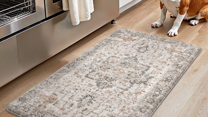 Beagle sitting beside a padded GENIMO anti-fatigue kitchen mat in front of the oven