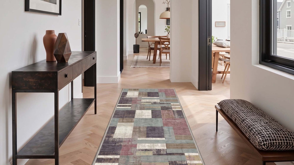 Low pile abstract beige runner rug in a hallway with a console table
