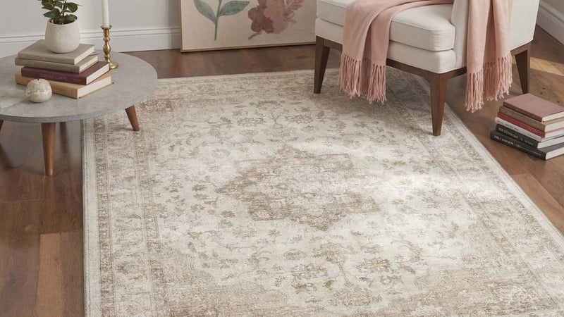 Beige Persian medallion washable rug in a bright living room with an armchair