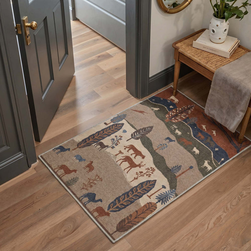 Millie Washable Woodland Animals Rug in entryway with tan, navy, rust and green woodland animals and feather pattern