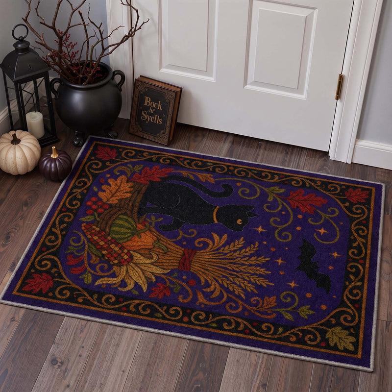 Rovell Washable Halloween Cat Purple Rug displayed on wood flooring in an entryway with white trim