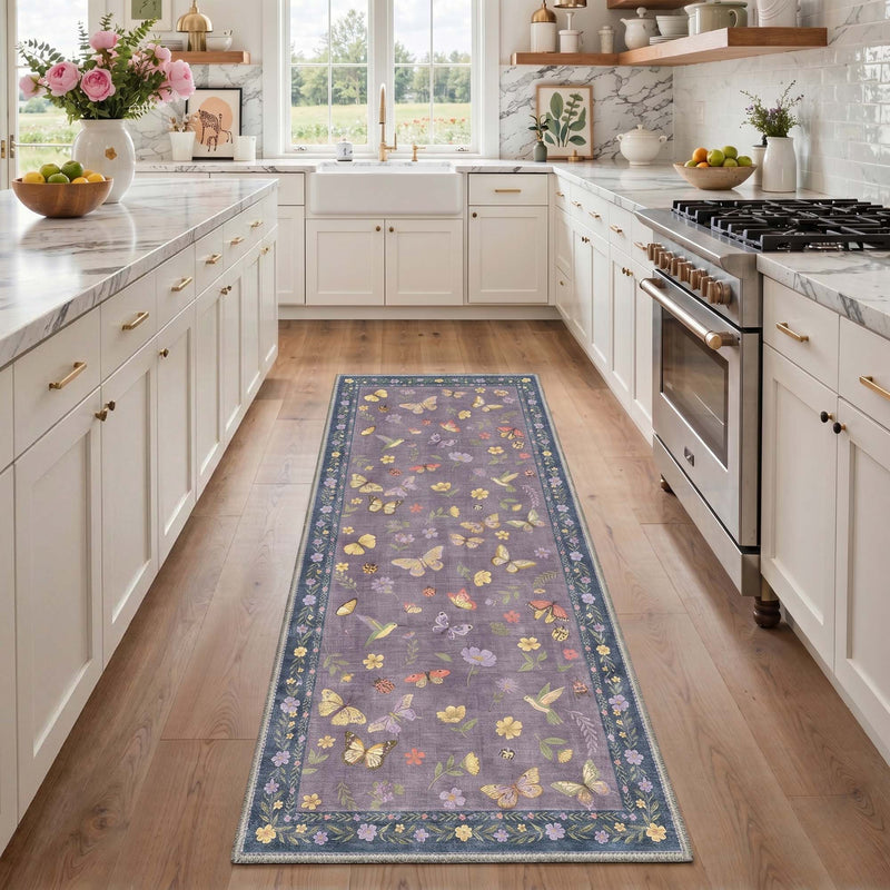 Alira Washable Butterflies Floral Purple Rug on wooden kitchen floor between white cabinets with purple background